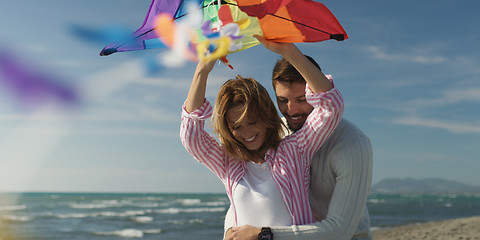 Image showing Happy couple having fun with kite on beach