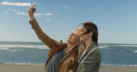 Image showing Girls having time and taking selfie on a beach