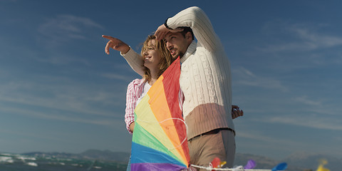 Image showing Happy couple having fun with kite on beach