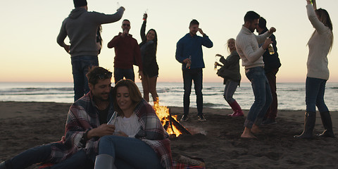 Image showing Friends having fun at beach on autumn day