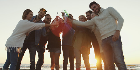 Image showing Friends on beach party drinking beer and having fun