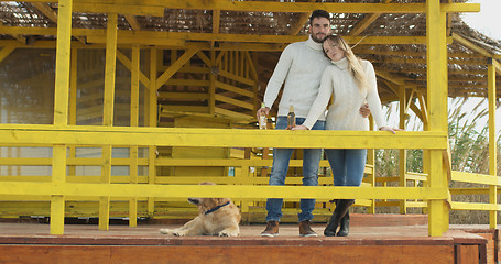 Image showing Couple drinking beer together at the beach