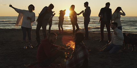 Image showing Friends having fun at beach on autumn day