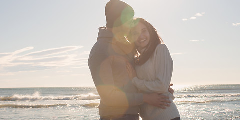 Image showing Couple having fun on beautiful autumn day at beach