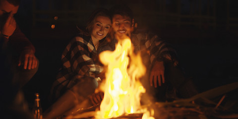 Image showing Couple enjoying with friends at night on the beach