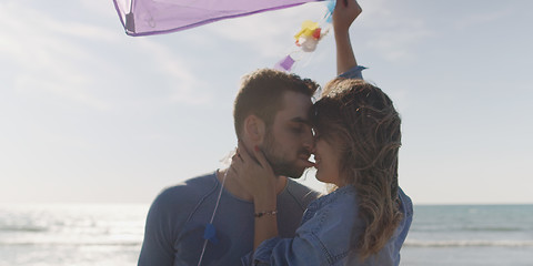 Image showing Happy couple having fun with kite on beach