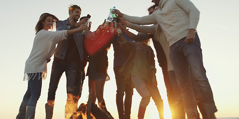 Image showing Friends on beach party drinking beer and having fun