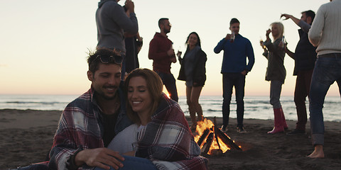 Image showing Friends having fun at beach on autumn day