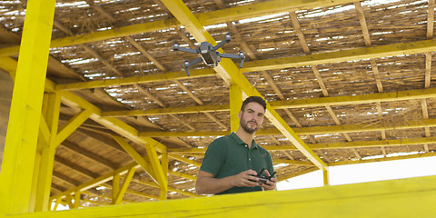 Image showing Man Operating Drone By The Sea