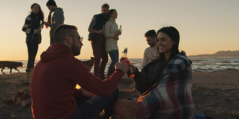 Image showing Friends having fun at beach on autumn day