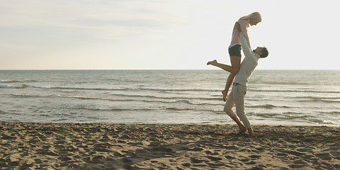 Image showing Loving young couple on a beach at autumn on sunny day