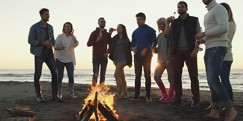 Image showing Friends having fun at beach on autumn day