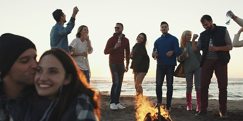 Image showing Friends having fun at beach on autumn day