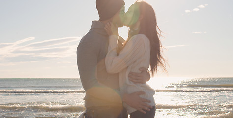 Image showing Couple having fun on beautiful autumn day at beach