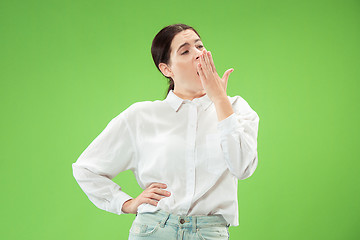 Image showing Beautiful bored woman bored isolated on green background