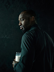 Image showing Healthy young african man holging milk