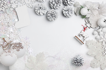 Image showing Christmas decorative composition of toys on a white background surrealism. Top view