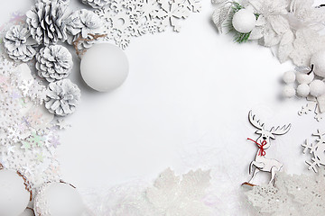 Image showing Christmas decorative composition of toys on a white background surrealism. Top view