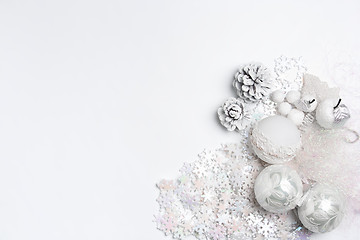 Image showing Christmas decorative composition of toys on a white background surrealism. Top view