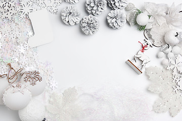 Image showing Christmas decorative composition of toys on a white background surrealism. Top view