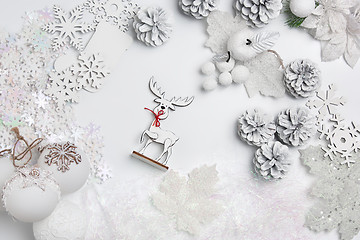 Image showing Christmas decorative composition of toys on a white background surrealism. Top view