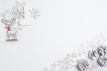 Image showing Christmas decorative composition of toys on a white background surrealism. Top view