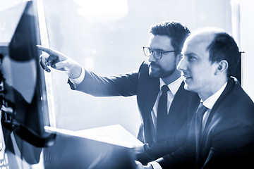 Image showing Business team analyzing data at business meeting in modern corporate office.