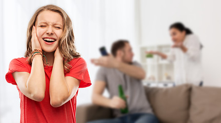 Image showing stressed girl over her parents having fight