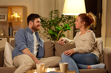 Image showing happy couple talking at home in evening