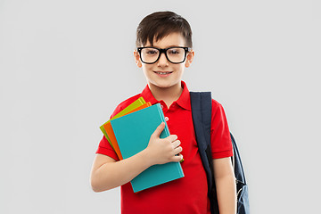 Image showing smiling schoolboy in glasses with books and bag