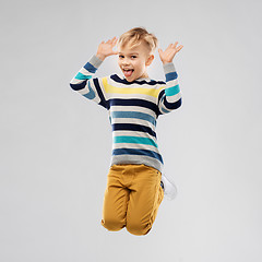 Image showing happy little boy jumping and having fun