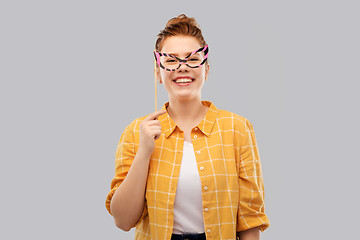 Image showing smiling red haired teenage girl with big glasses