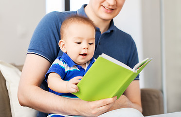 Image showing happy father and little baby son with book at home