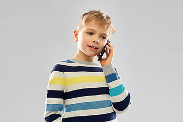 Image showing boy in striped pullover calling on smartphone