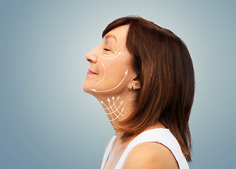 Image showing profile of senior woman with face lifting arrows