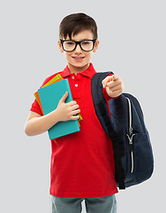 Image showing smiling schoolboy in glasses with books and bag