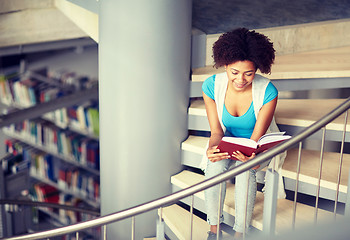 Image showing african student girl reading book at library