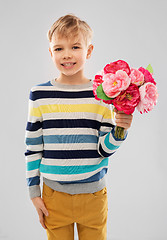 Image showing smiling boy with bunch of peony flowers