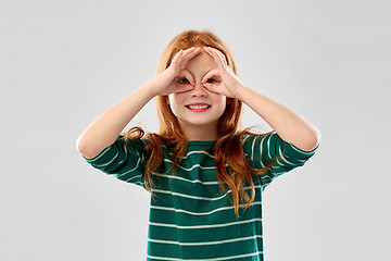 Image showing red haired girl looking through finger glasses