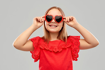 Image showing smiling preteen girl with heart shaped sunglasses