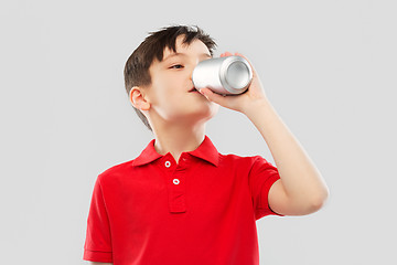 Image showing boy in red t-shirt drinking soda from tin can