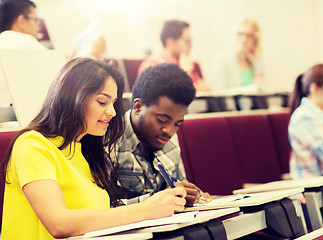 Image showing group of students with notebooks in lecture hall