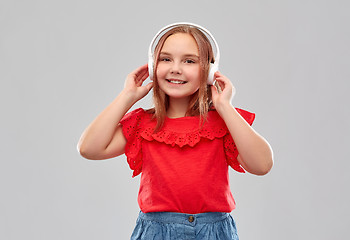 Image showing smiling girl in headphones listening to music