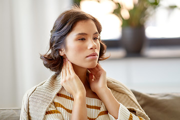 Image showing sick woman touching her lymph nodes at home