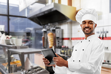 Image showing male indian chef with tablet pc at kebab shop