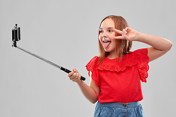 Image showing girl taking picture by smartphone on selfie stick