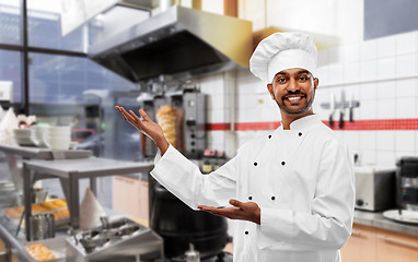 Image showing happy male indian chef in toque at kebab shop