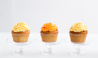 Image showing cupcakes with frosting on confectionery stands