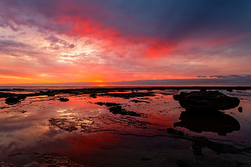 Image showing Sunrise seascape at low tide with vivid reflections