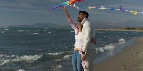 Image showing Happy couple having fun with kite on beach